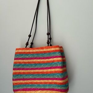 Straw handbag with fabric lining and a zippered pocket.